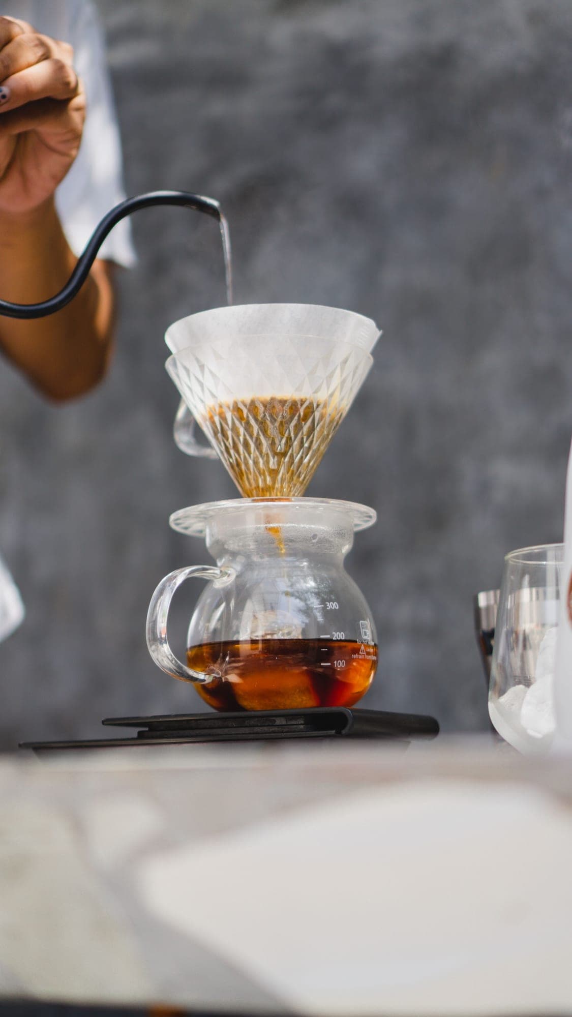Pouring water over a V60 filter at the Artha brew bar
